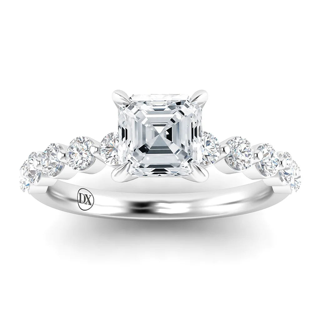Asscher-cut diamond ring with a silver band and round diamonds set along the band’s shoulders.