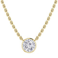Gold chain necklace with a round, bezel-set clear diamond pendant on a white background.