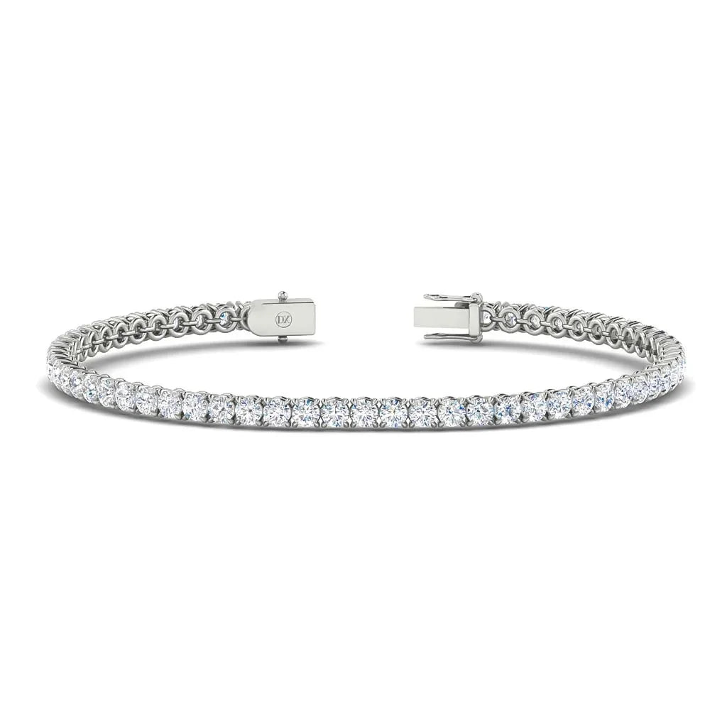 A white gold tennis bracelet featuring a row of round, brilliant-cut diamonds and a secure clasp.