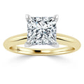 Princess-cut diamond solitaire ring with yellow gold band and white gold prongs, shown on a white background.