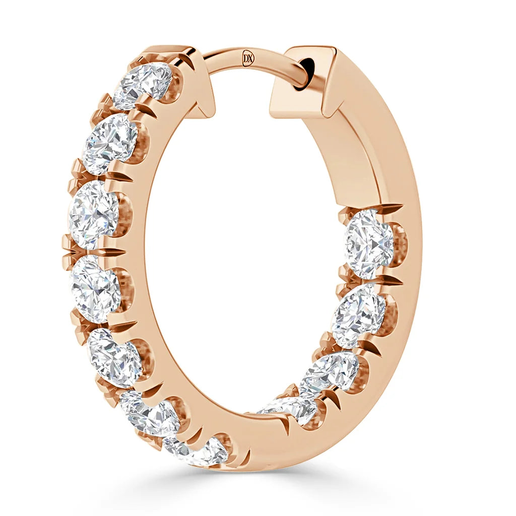 A rose gold hoop earring set with round, sparkling white gemstones around the outer edge.