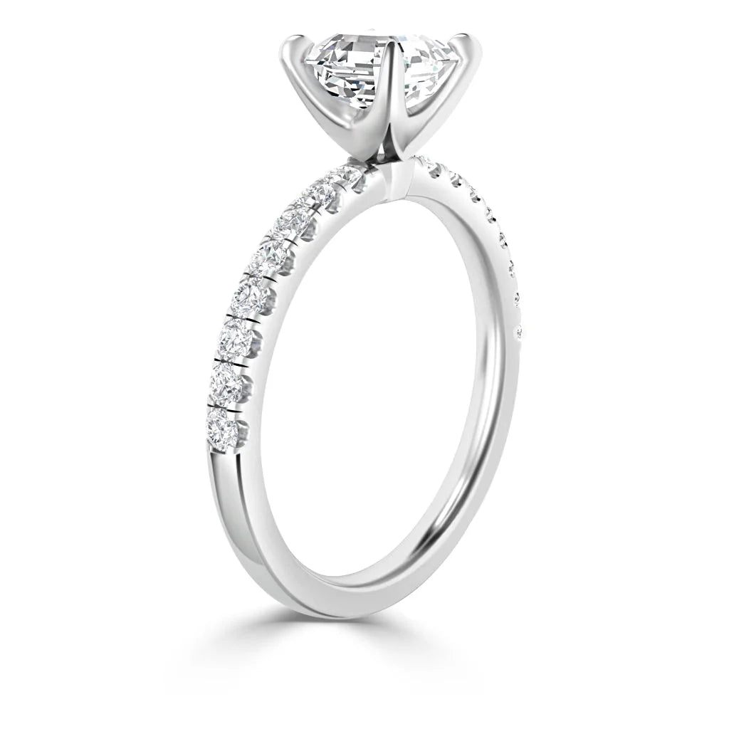 A white gold engagement ring with a large center diamond and smaller diamonds set along the band.