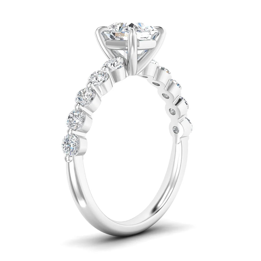A white gold ring with a large round center diamond and six smaller side diamonds set along the band.