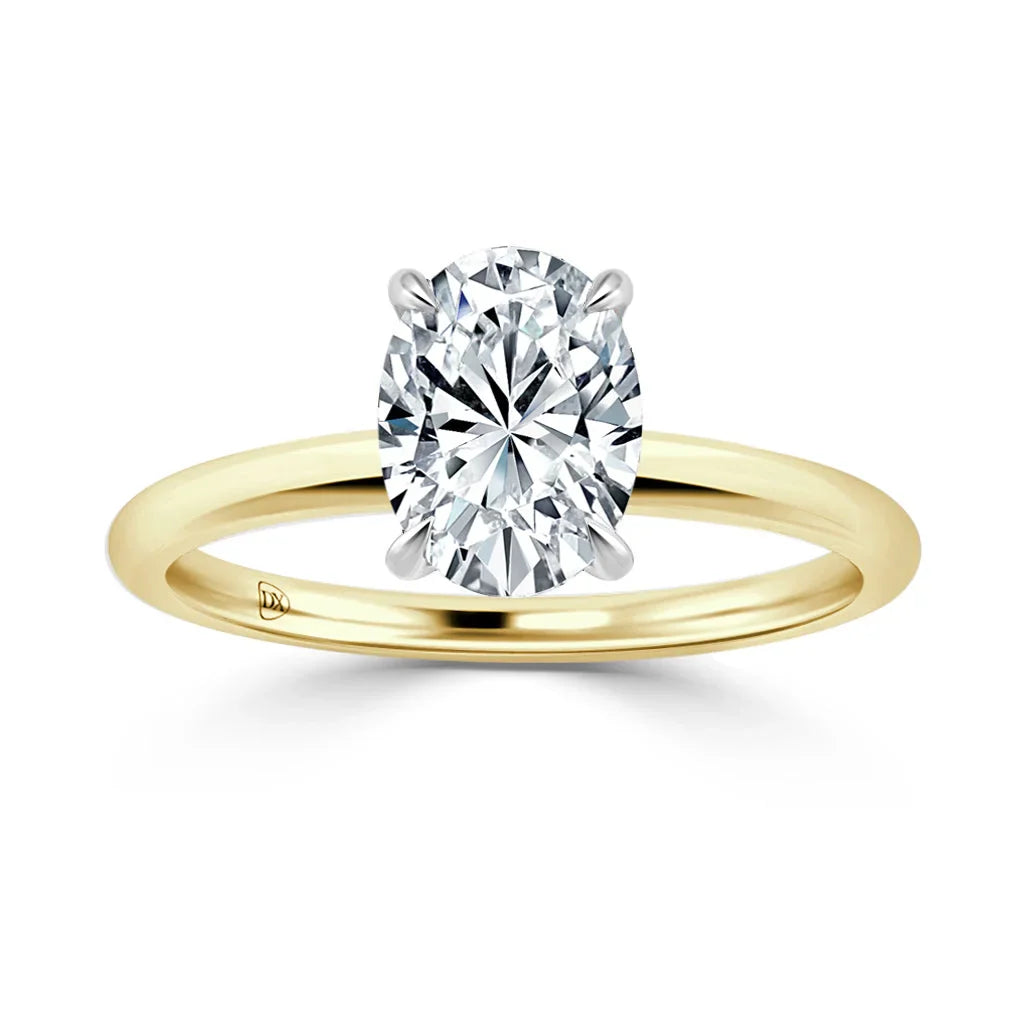 Gold band solitaire ring with an oval-cut diamond in a four-prong setting, on a white background.