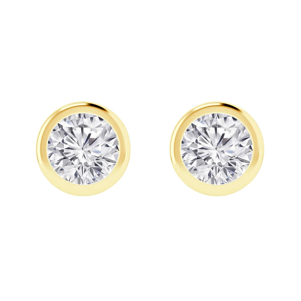 A pair of round diamond stud earrings set in yellow gold bezel settings on a white background.