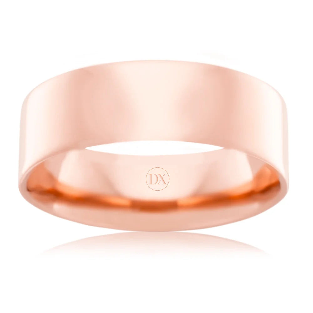 Shiny, plain rose gold wedding band with a smooth surface and the engraved letters DX inside.