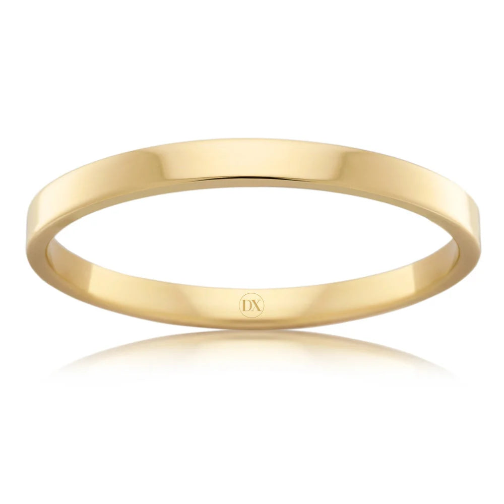 Simple yellow gold band ring with a polished finish and a small DX engraving on the inner side.