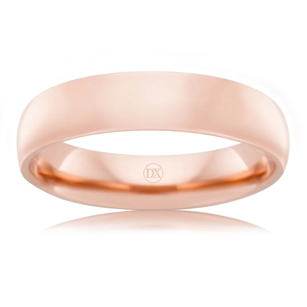A simple, polished rose gold band ring with a smooth surface and DX engraved inside.