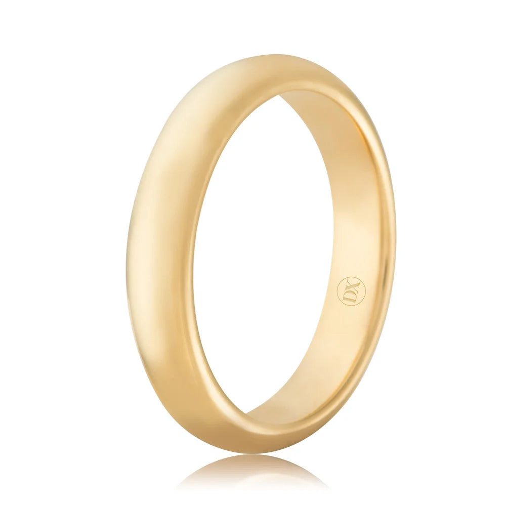 A simple, polished gold band ring with a smooth finish and a small engraved symbol inside.