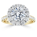 Gold ring with large central diamond, halo of smaller diamonds, and diamond accents along the band.