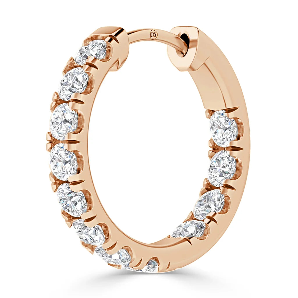 A rose gold hoop earring with a row of round white diamonds set along its outer edge.