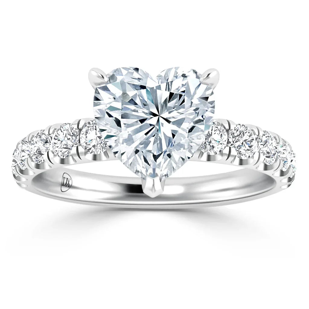 Heart-shaped diamond ring with round diamonds on a silver band, shown from the front on a white background.