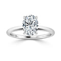 A silver band ring with a single oval-shaped diamond set in a four-prong solitaire setting.