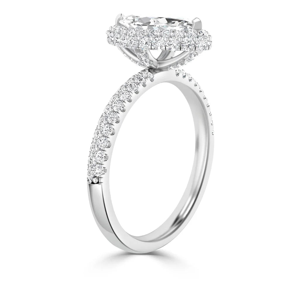 Side view of a white gold ring with a large oval diamond and a pavé diamond halo and band.