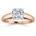 Rose gold ring with a large cushion-cut diamond in a four-prong setting, on a plain band.