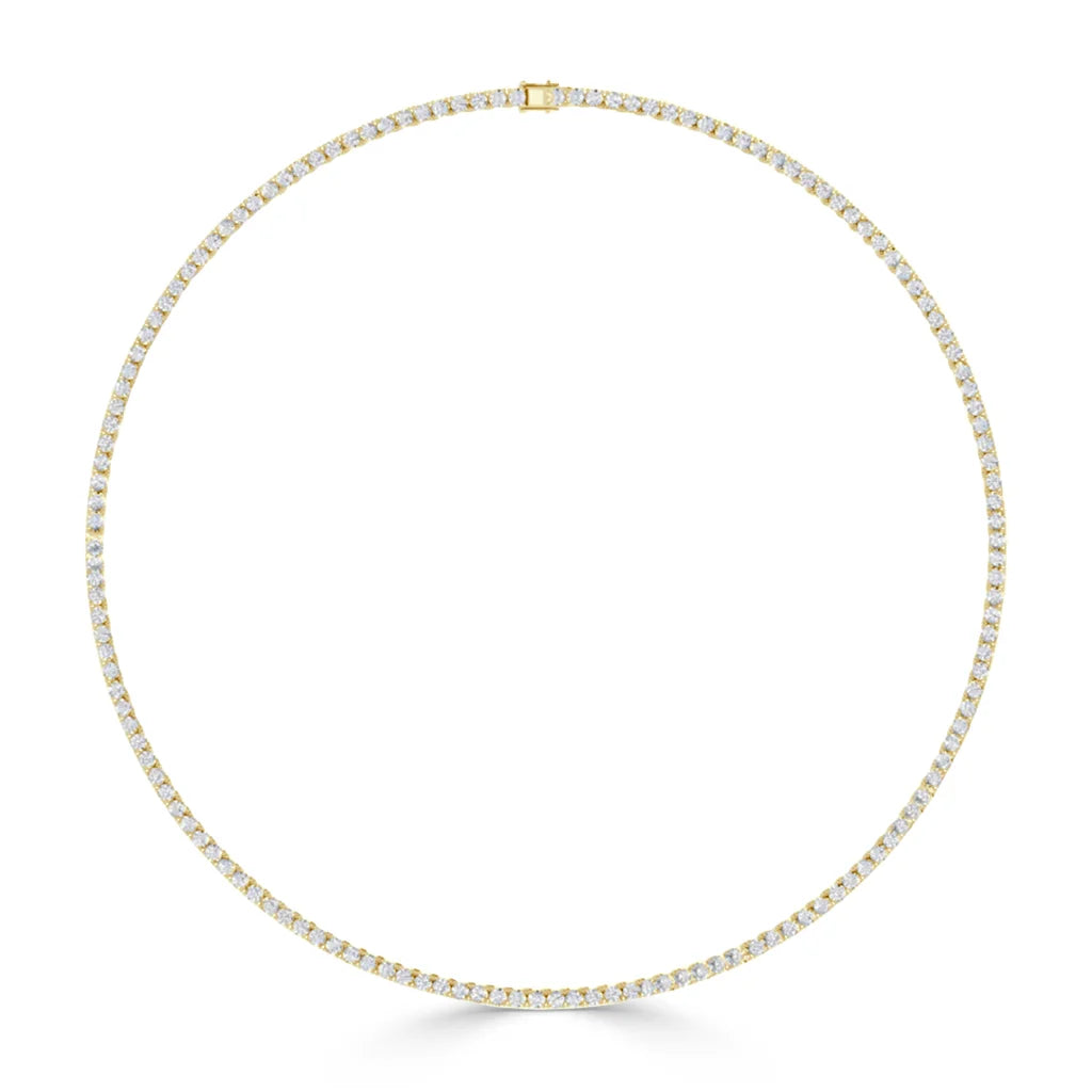 Gold tennis necklace with evenly spaced clear gemstones forming a perfect circle on a white background.