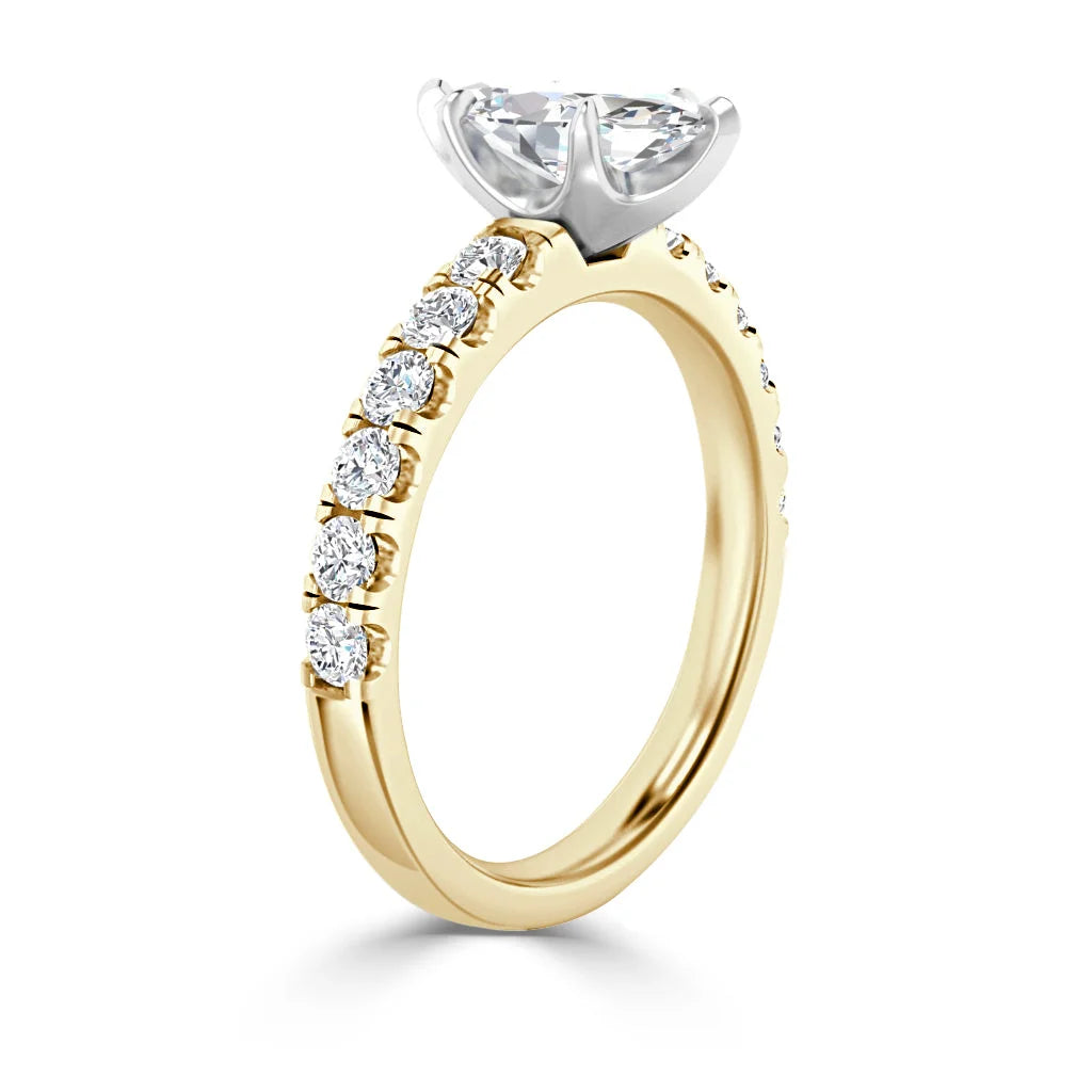 Gold engagement ring with a large center diamond and smaller diamonds set along the band.