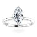 A marquise-cut diamond solitaire ring with a sleek, polished white gold band on a white background.