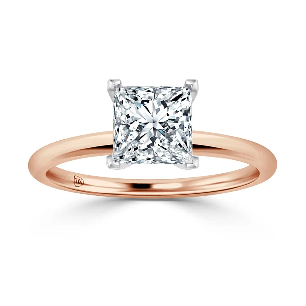 Rose gold ring with a square-cut diamond solitaire set in a four-prong white gold setting, shown on white background.