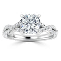 Platinum ring with a cushion-cut center diamond and twisted band adorned with small diamonds.