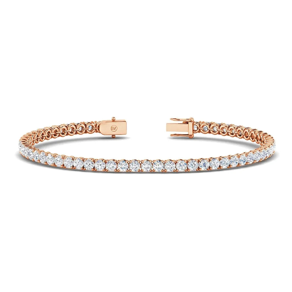 A rose gold tennis bracelet with a row of sparkling round white diamonds and a clasp closure.