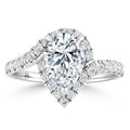 A pear-shaped diamond ring with a halo setting and a diamond-encrusted split shank band.