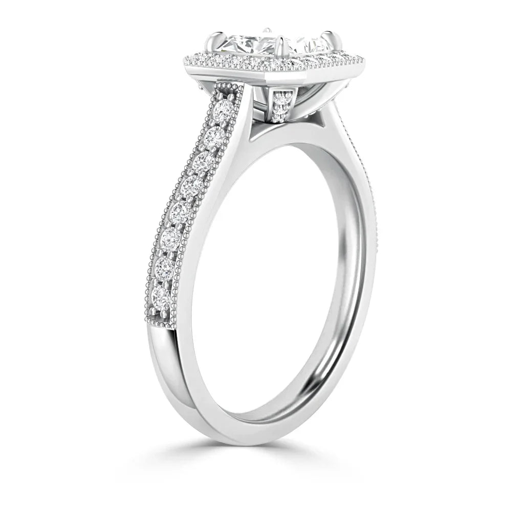 White gold ring with a round center diamond and pavé diamonds along the split shank and setting.