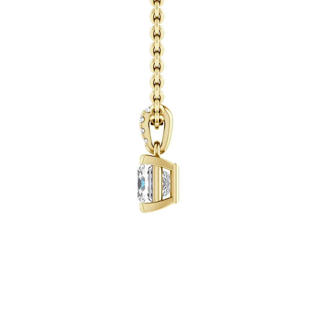 Side view of a gold necklace with a square-shaped pendant featuring a large clear gemstone.