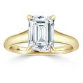 Gold ring with a large emerald-cut diamond solitaire set in four prongs, shown on a plain white background.
