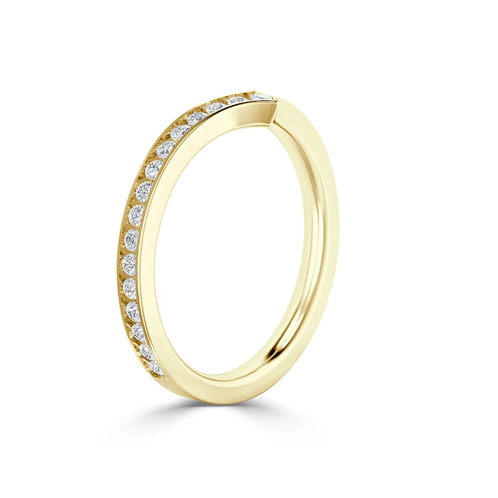 Gold ring with round diamonds set along half of the band, shown on a white background.