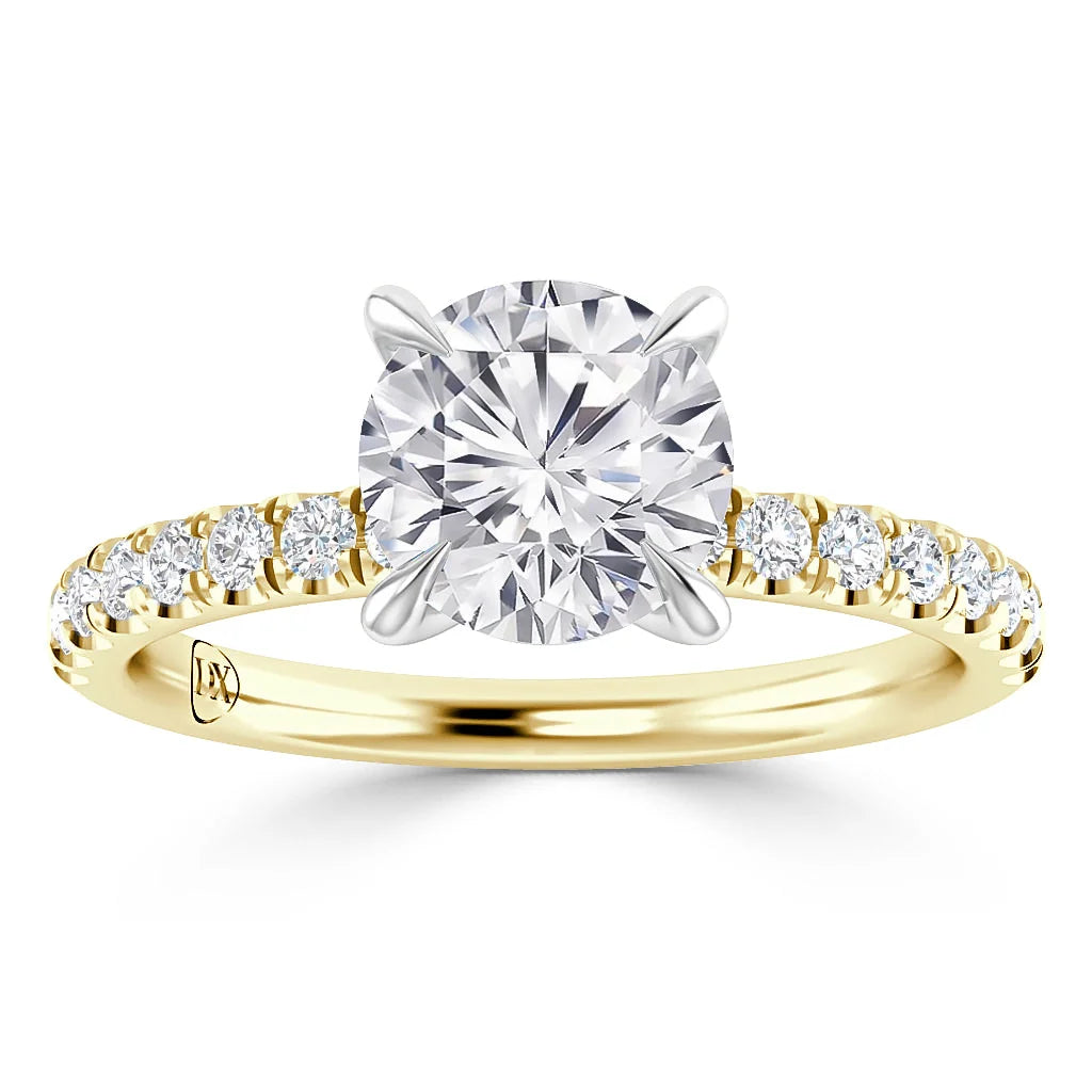 A gold ring with a large round center diamond and smaller diamonds set along the band.