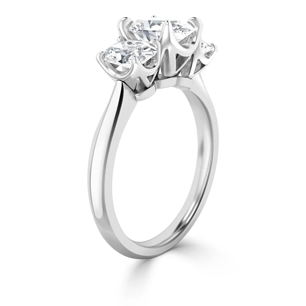 A silver ring with three round diamonds set in prongs, viewed from a side angle on a white background.