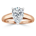 A pear-shaped diamond solitaire ring with a rose gold band, shown against a white background.