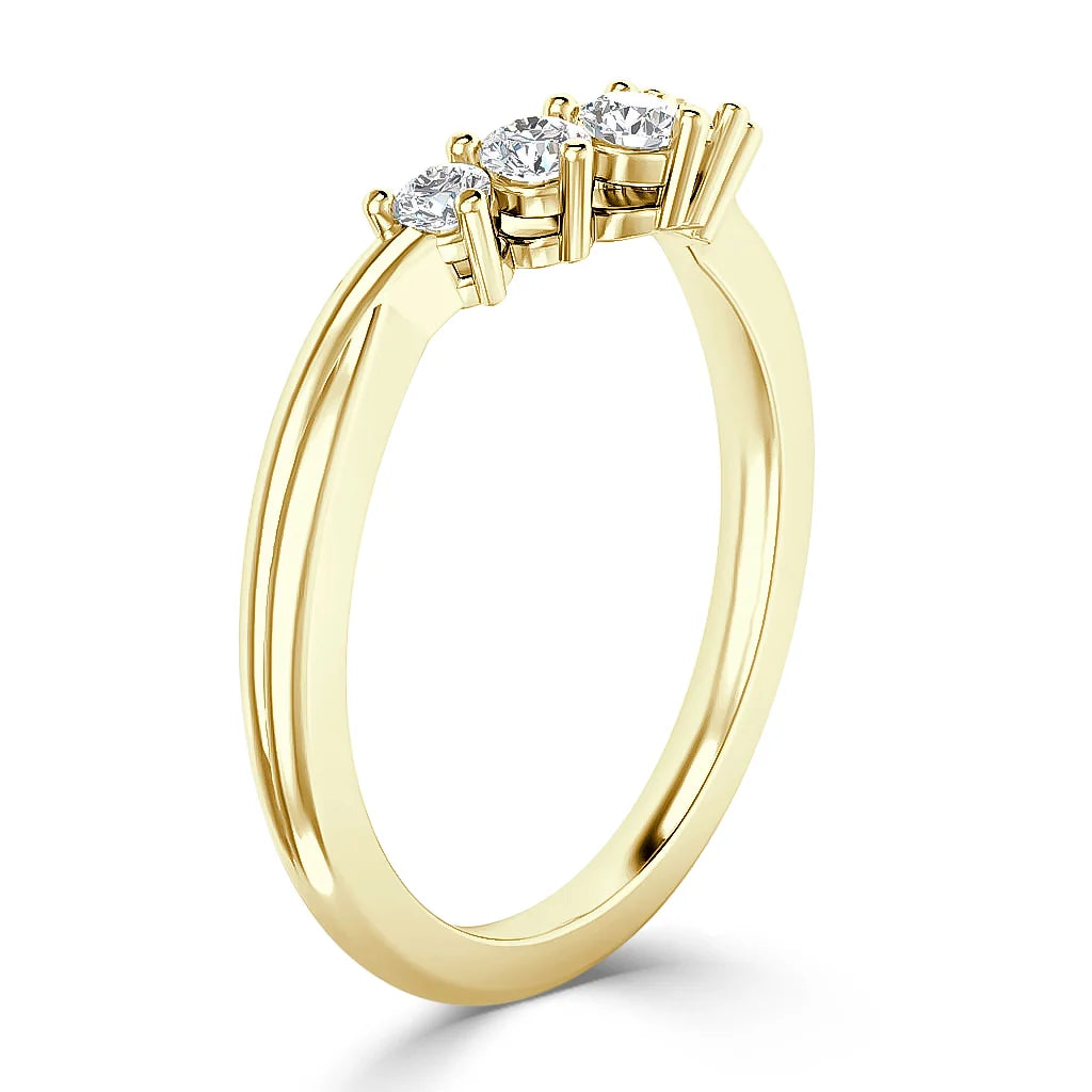 A gold ring with three round diamonds set in prongs on a slim, polished band.