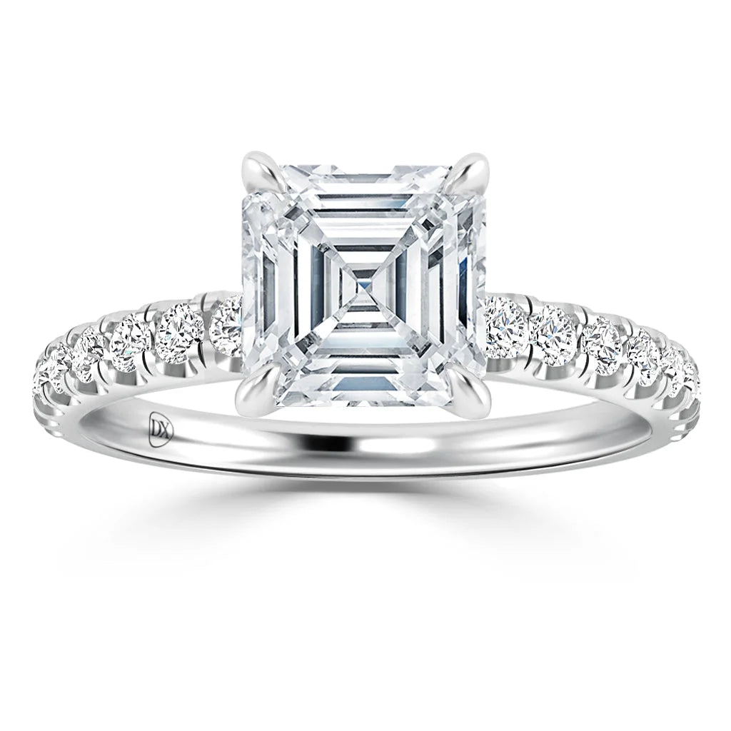 A platinum ring with an Asscher-cut diamond center, flanked by smaller round diamonds on the band.