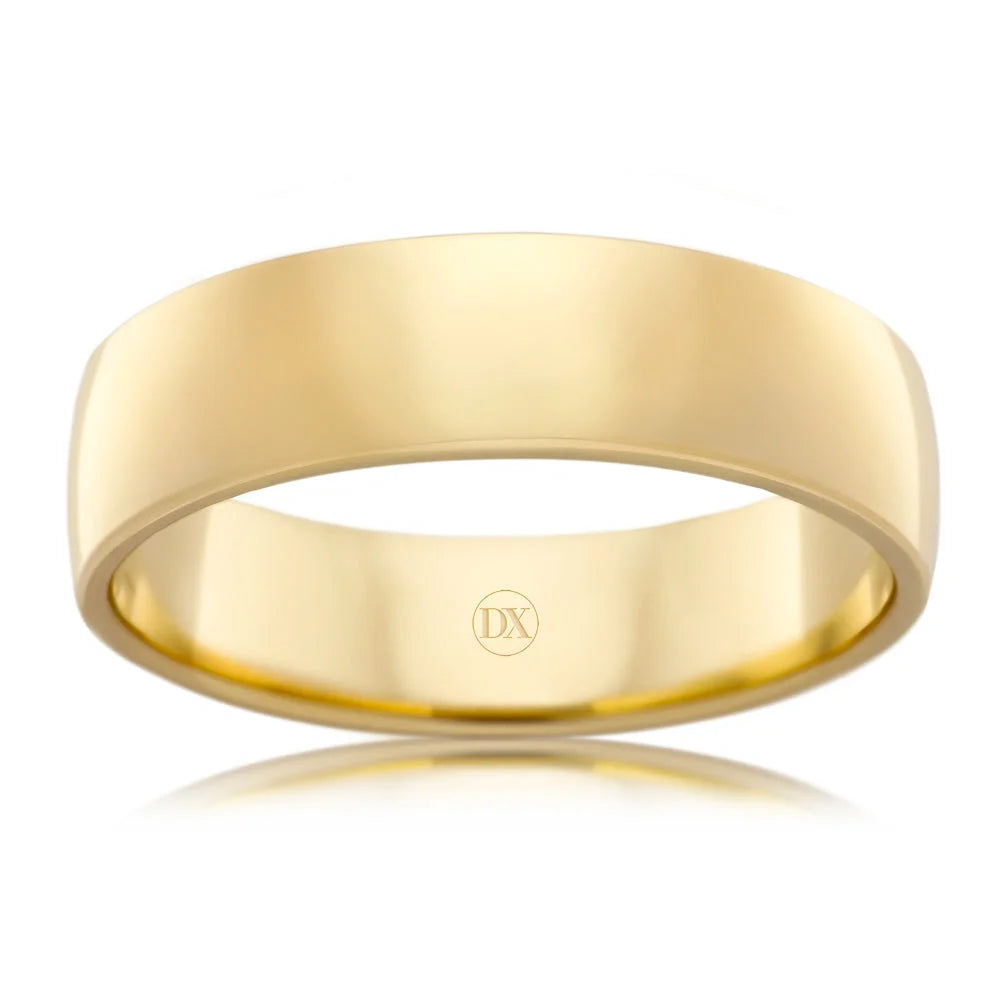 A simple, polished yellow gold wedding band with a flat edge, engraved with “DX” inside.