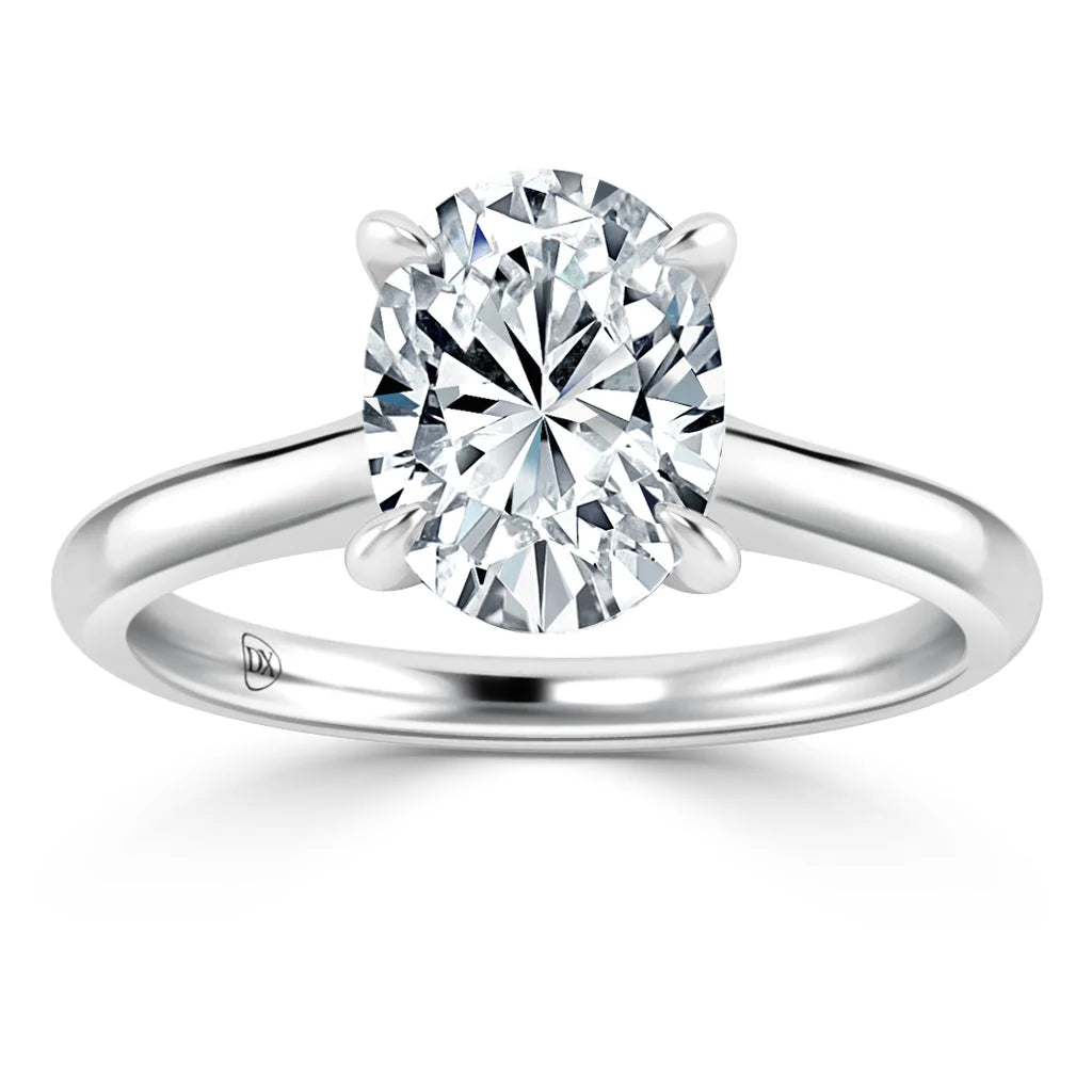 A silver band solitaire ring with an oval-cut diamond held by four prongs, shown on a white background.
