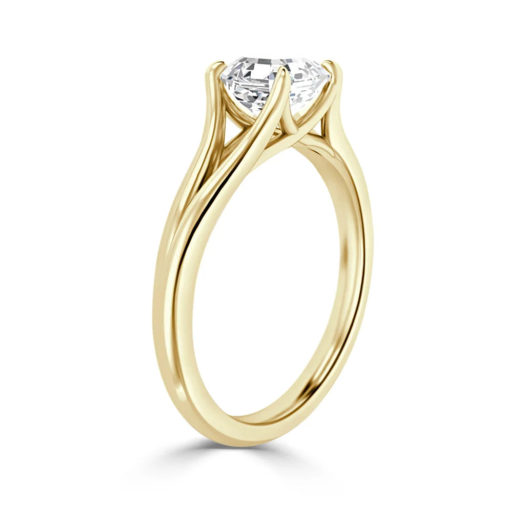 Yellow gold ring with a twisted band and a round solitaire diamond in a prong setting, side view.