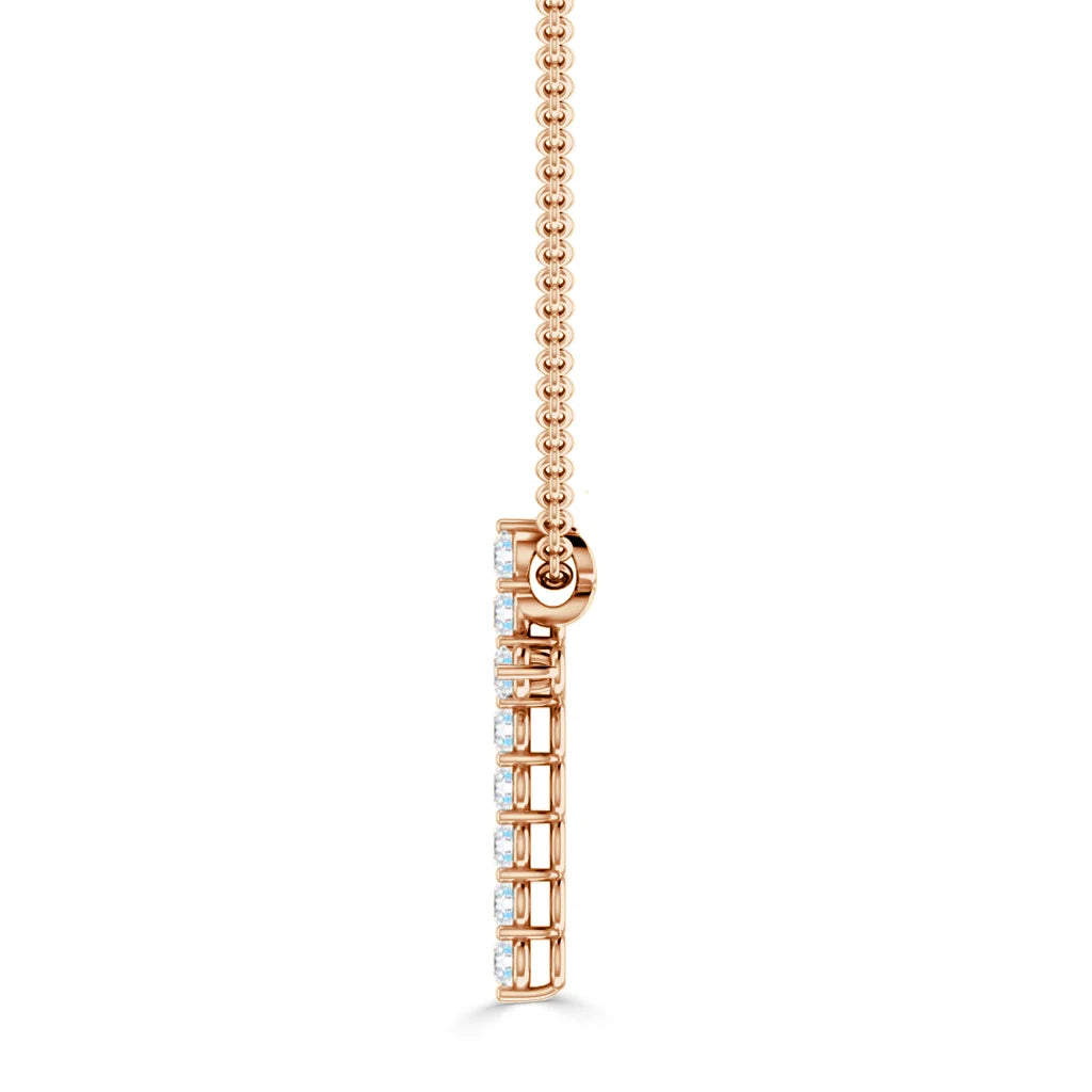 Side view of a rose gold necklace with a vertical diamond pendant on a delicate chain.