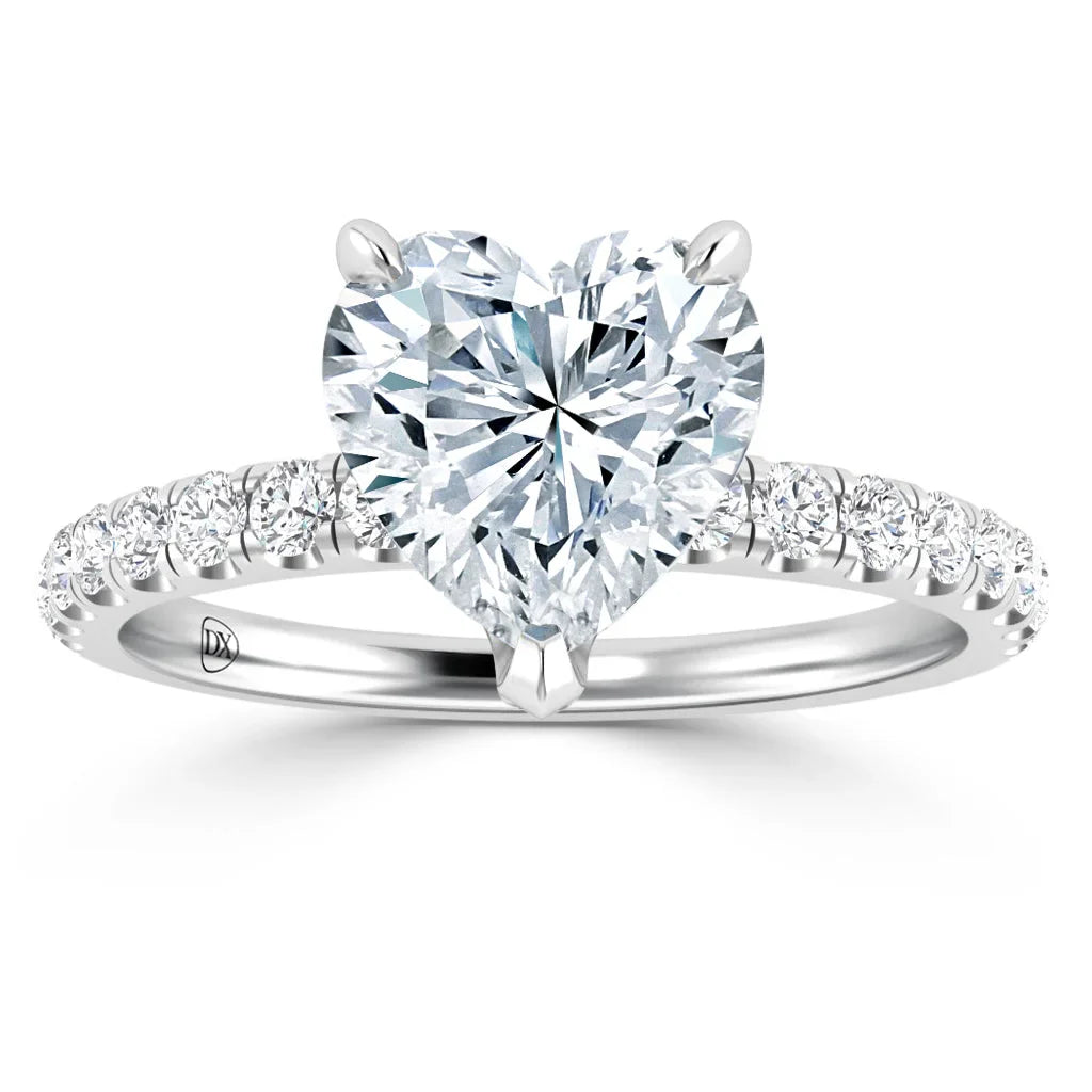 Heart-shaped diamond ring with a silver band and round diamonds set along the band’s upper half.