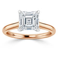 Rose gold band ring with a large square-cut diamond in a four-prong setting, shown on a white background.