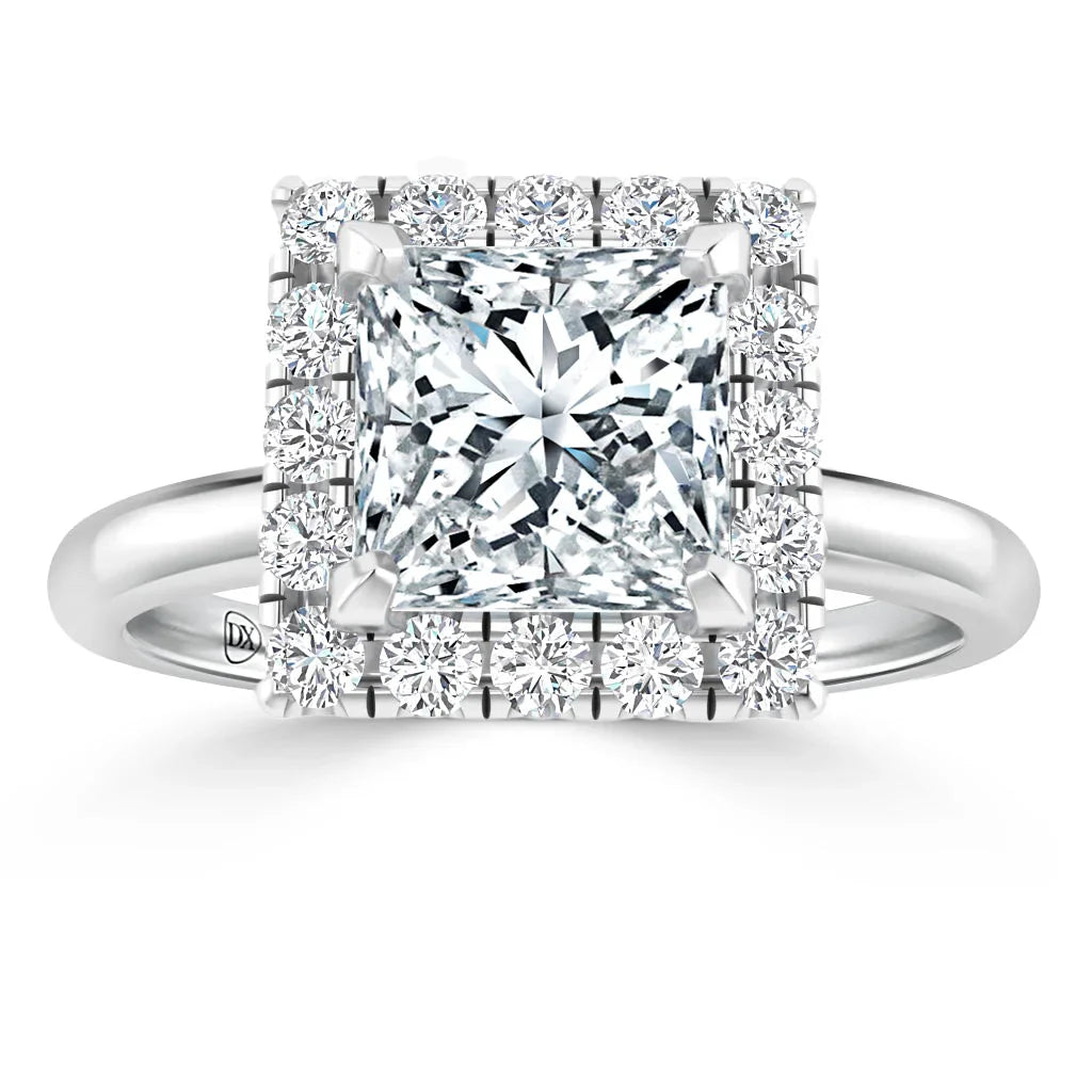 A square diamond ring with a halo of smaller round diamonds set in a silver band, shown from the front.