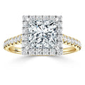 Gold ring with a large square diamond, surrounded by smaller diamonds on the band and halo setting.