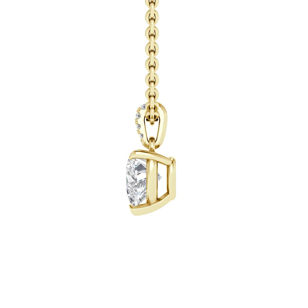 A gold chain with a geometric pendant holding a heart-shaped clear gemstone and small round accent stones.