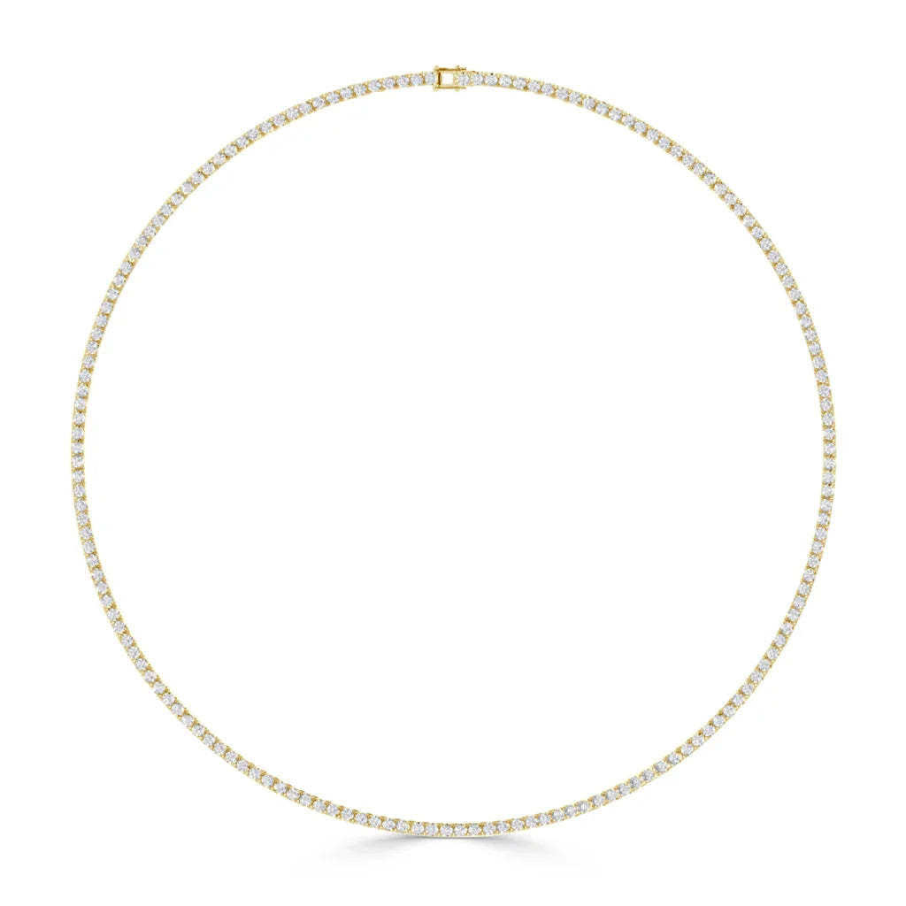 Gold tennis necklace set with evenly spaced small round diamonds, displayed in a circular shape on white background.