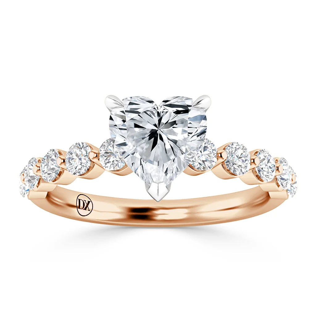 Rose gold ring with a heart-shaped diamond center and round diamonds along the band, shown on a white background.