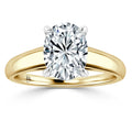 A gold band ring with an oval-cut diamond solitaire held by four prongs against a white background.