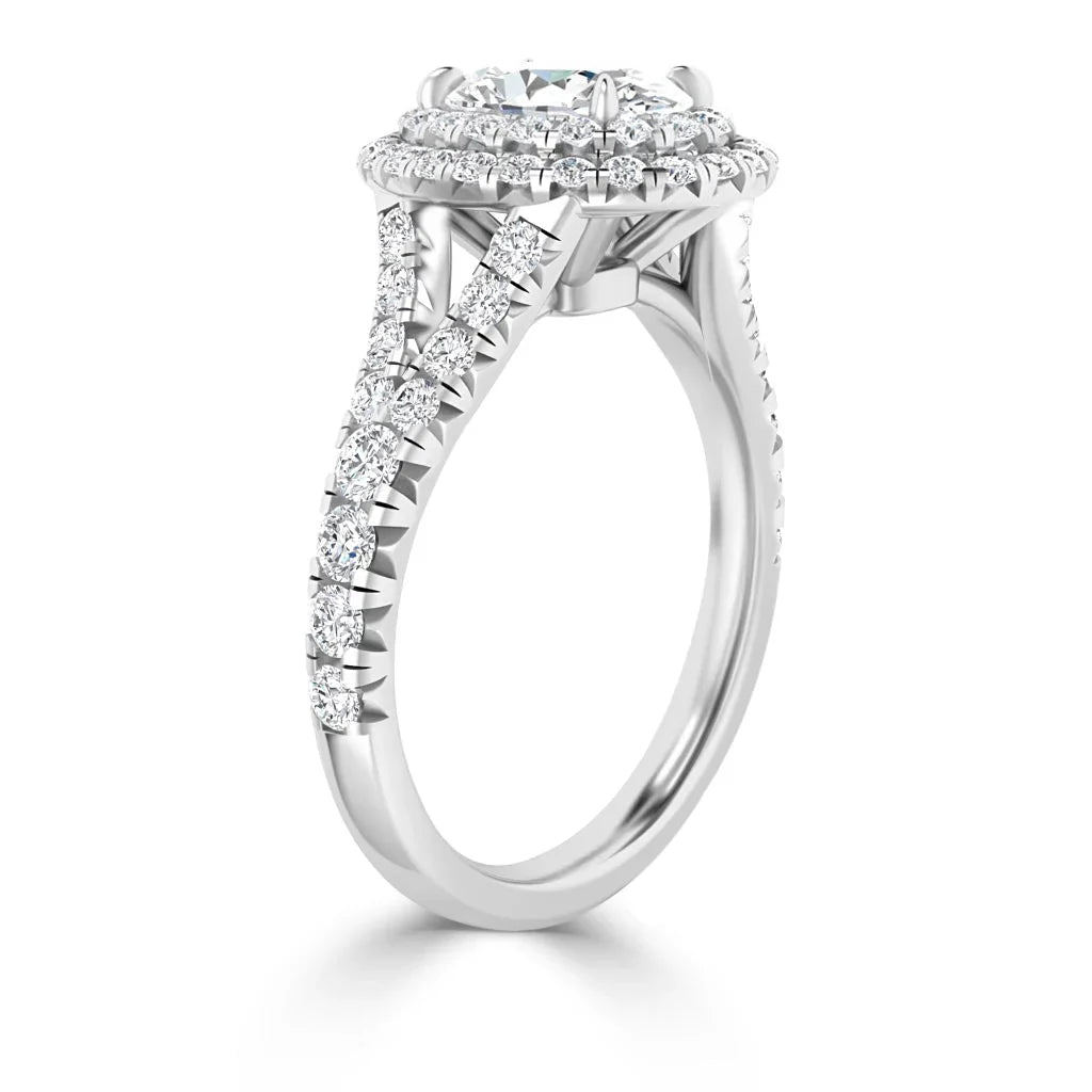 White gold ring with a round center diamond, double halo, and diamond accents along the twisted band.