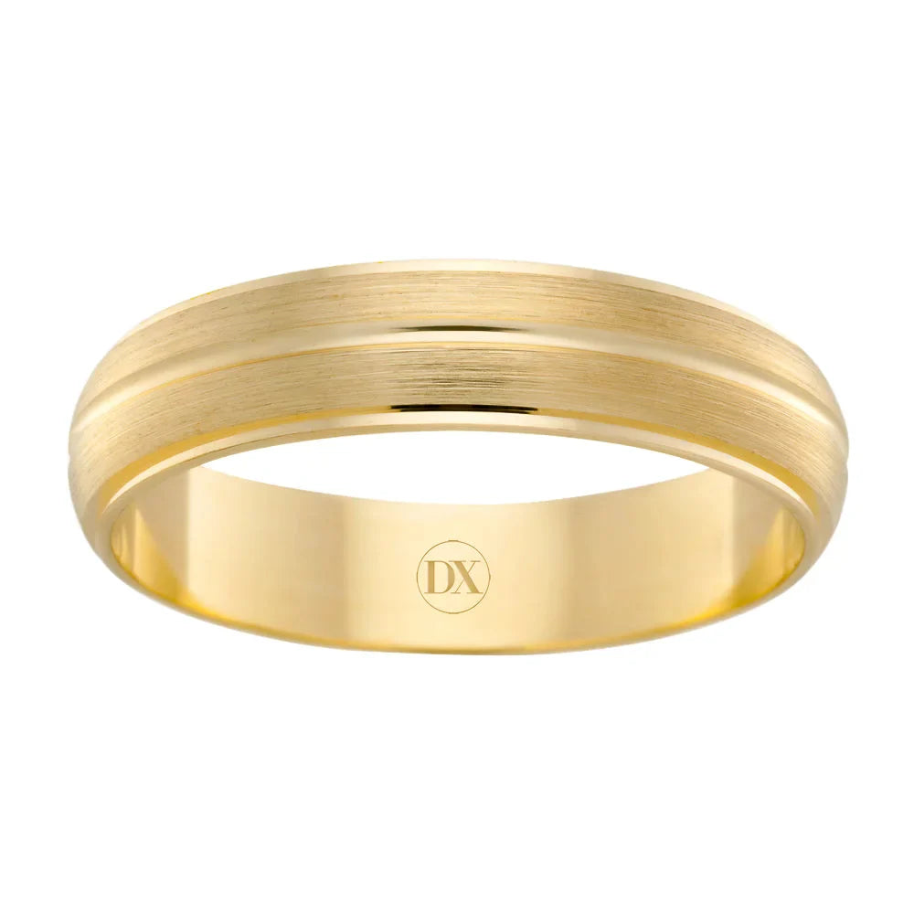 A gold wedding band with a brushed center stripe and a polished engraved DX inside the band.