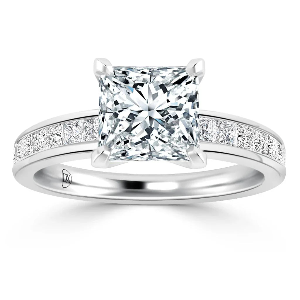A platinum ring with a large princess-cut diamond and smaller diamonds set along the band.